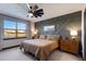 Main bedroom with large window, ceiling fan and dresser at 3324 Big Sky Way, Lakewood Ranch, FL 34211