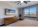 Main bedroom with large window, dresser and a TV at 3324 Big Sky Way, Lakewood Ranch, FL 34211