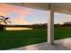 Covered patio with sunset view of lake and community at 3324 Big Sky Way, Lakewood Ranch, FL 34211