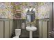 Charming powder room with floral wallpaper and pedestal sink at 3324 Big Sky Way, Lakewood Ranch, FL 34211