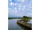 Wooden bridge over calm water, surrounded by lush greenery at 3354 Founders Club Dr, Sarasota, FL 34240