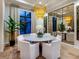 Elegant dining room with a marble table, chandelier, and large mirror at 3354 Founders Club Dr, Sarasota, FL 34240