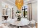 Bright dining room featuring a round marble table and stylish chandelier at 3354 Founders Club Dr, Sarasota, FL 34240