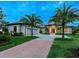 Stunning curb appeal with palm trees and brick driveway at 3354 Founders Club Dr, Sarasota, FL 34240