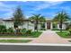 Stunning two-story home with palm trees and brick paver driveway at 3354 Founders Club Dr, Sarasota, FL 34240