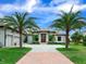 Two-story home with a beautiful entryway, lush landscaping and palm trees at 3354 Founders Club Dr, Sarasota, FL 34240