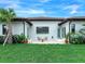 Private backyard patio with seating area and lush landscaping at 3354 Founders Club Dr, Sarasota, FL 34240