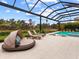 Inviting pool area with covered patio, lounge chairs, and spa at 3354 Founders Club Dr, Sarasota, FL 34240