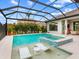 Stunning pool and spa with covered patio and adjacent outdoor kitchen at 3354 Founders Club Dr, Sarasota, FL 34240