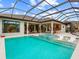 Resort-style pool and spa with covered patio and outdoor kitchen at 3354 Founders Club Dr, Sarasota, FL 34240