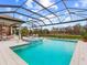 Resort-style pool and spa with covered patio and outdoor kitchen at 3354 Founders Club Dr, Sarasota, FL 34240