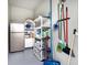 Well-lit storage room with shelving, refrigerator, and cleaning supplies at 3354 Founders Club Dr, Sarasota, FL 34240