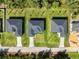 Aerial view of three new homes with grey roofs and green lawns at 3397 Dryden St, North Port, FL 34288