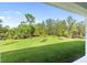 View of a backyard with green lawn and lush vegetation at 3397 Dryden St, North Port, FL 34288