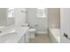 Simple bathroom with a bathtub, single vanity, and tile flooring at 3397 Dryden St, North Port, FL 34288