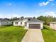 New construction home with a two-car garage and landscaped lawn at 3397 Dryden St, North Port, FL 34288