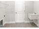 Bright laundry room, featuring a utility sink, built-in shelving and tile flooring at 3397 Dryden St, North Port, FL 34288