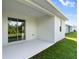 Covered patio with sliding glass doors leading to the backyard at 3397 Dryden St, North Port, FL 34288