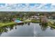 Aerial view of community pool, lake, and tennis courts at 365 Oak Hill Way # 32, Sarasota, FL 34232