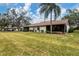 Landscaped backyard with spacious lawn and partial home view at 365 Oak Hill Way # 32, Sarasota, FL 34232