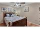 Guest bedroom with a wooden bed frame and coastal-themed decor at 365 Oak Hill Way # 32, Sarasota, FL 34232