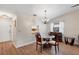 Dining area with glass-top table, four chairs, and chandelier at 365 Oak Hill Way # 32, Sarasota, FL 34232