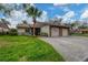 Two-car garage, attractive landscaping, and a spacious driveway at 365 Oak Hill Way # 32, Sarasota, FL 34232