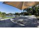 Relaxing patio area with tables, chairs, and shade umbrellas at 365 Oak Hill Way # 32, Sarasota, FL 34232