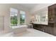 Elegant bathroom featuring a freestanding tub and marble floors at 3761 Founders Club Dr, Sarasota, FL 34240