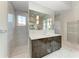 Modern bathroom with dark wood cabinets and marble floors at 3761 Founders Club Dr, Sarasota, FL 34240