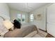 Bright bedroom with a queen-size bed and large windows at 3761 Founders Club Dr, Sarasota, FL 34240