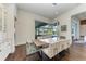 Modern dining room with glass table and view of the pool and lanai at 3761 Founders Club Dr, Sarasota, FL 34240