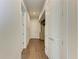 Bright hallway with hardwood floors and access to other rooms at 3761 Founders Club Dr, Sarasota, FL 34240