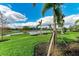 Lush landscaping with palm trees and a pond at 3761 Founders Club Dr, Sarasota, FL 34240