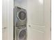 Stackable washer and dryer in a closet at 3761 Founders Club Dr, Sarasota, FL 34240