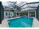 Large pool and spa with covered lanai and luxurious lounge chairs at 3761 Founders Club Dr, Sarasota, FL 34240