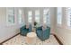 Cozy sitting area with teal armchairs and a neutral rug at 3761 Founders Club Dr, Sarasota, FL 34240