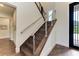 Modern staircase with wood steps and cable railing at 3761 Founders Club Dr, Sarasota, FL 34240