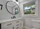 Modern bathroom with white vanity, large mirror, and window at 3902 11Th W Ave, Bradenton, FL 34205