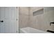 Renovated bathroom with a bathtub and neutral tile at 3902 11Th W Ave, Bradenton, FL 34205