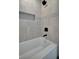 Clean bathroom with neutral tile and a bathtub at 3902 11Th W Ave, Bradenton, FL 34205