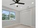 Bright bedroom with wood-look floors, ceiling fan, and window at 3902 11Th W Ave, Bradenton, FL 34205