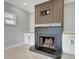 Modern gray tile fireplace with wood-look mantel and built-in shelving at 3902 11Th W Ave, Bradenton, FL 34205