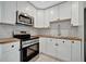 Modern kitchen with white cabinets, stainless steel appliances and butcher block countertops at 3902 11Th W Ave, Bradenton, FL 34205