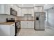 Modern kitchen with white cabinets, stainless steel appliances, and wood countertops at 3902 11Th W Ave, Bradenton, FL 34205