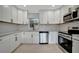 Modern kitchen with white cabinets and stainless steel appliances at 3902 11Th W Ave, Bradenton, FL 34205