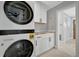 Modern laundry room with stacked washer and dryer, cabinets and countertop at 3902 11Th W Ave, Bradenton, FL 34205