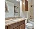 Clean bathroom with granite vanity, shower, and built-in cabinet at 4020 Cascina Way, Sarasota, FL 34238