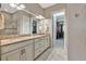 Bathroom boasts double sinks, granite counters, and access to a large walk-in closet at 4020 Cascina Way, Sarasota, FL 34238