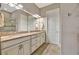 Elegant bathroom with double vanity, granite countertop, and a walk-in shower at 4020 Cascina Way, Sarasota, FL 34238